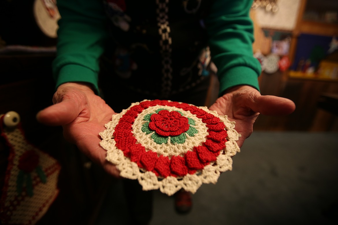 Ginger Wright holds one of the festively crafted potholders in her Christmas collection. Overall, the retired Coeur d'Alene teacher has at least 500 potholders. "Every season, for every reason," she said.