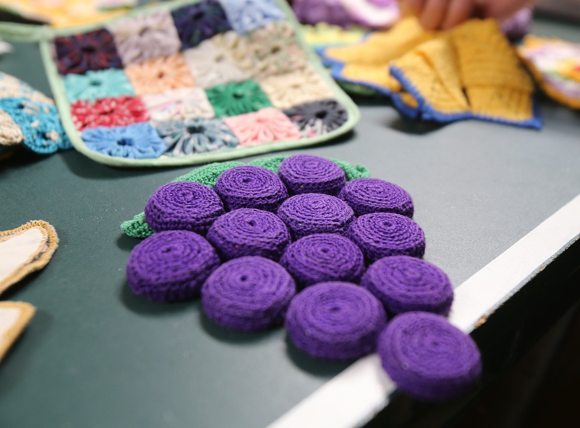 A crocheted potholder with grapes made of cork-stuffed bottlecaps is one of the many creative pieces in Ginger Wright's extensive potholder collection.