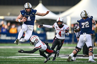 Montana State quarterback Tommy Mellott (4) hurdles a defender on a 41-yard touchdown run in the third quarter during an FCS semifinal game against South Dakota at Bobcat Stadium on Saturday, Dec. 21. (Casey Kreider/Daily Inter Lake)