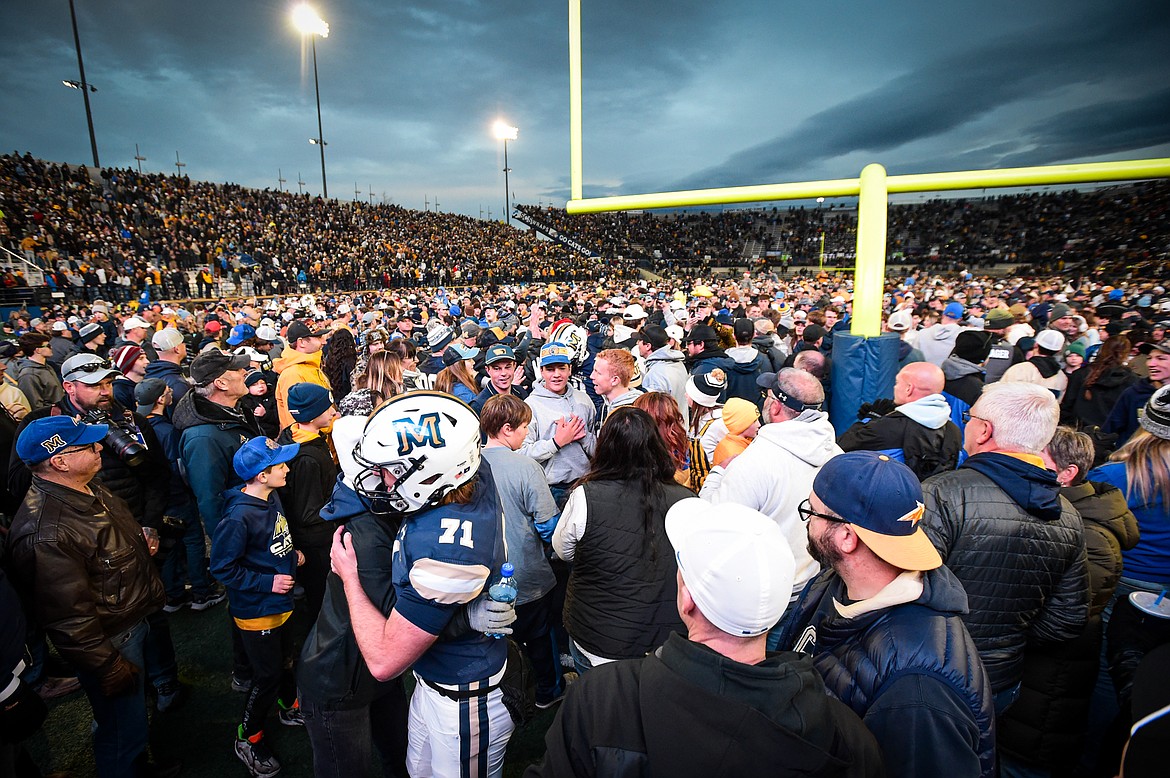 Montana State fans celebrate on the field with the Bobcats after a 31-17 win over South Dakota in an FCS semifinal game at Bobcat Stadium on Saturday, Dec. 21. (Casey Kreider/Daily Inter Lake)