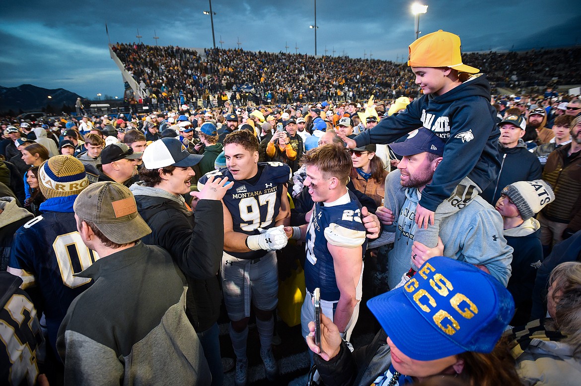 Montana State fans celebrate on the field with the Bobcats after a 31-17 win over South Dakota in an FCS semifinal game at Bobcat Stadium on Saturday, Dec. 21. (Casey Kreider/Daily Inter Lake)