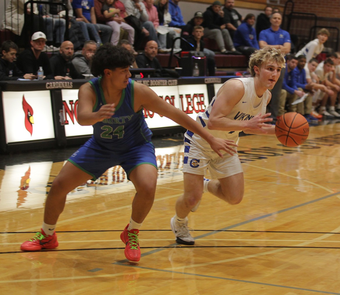 JASON ELLIOTT/Press
Coeur d'Alene sophomore guard Ben Murray attempts to drive by Liberty sophomore guard Tyson Burley during the first quarter of Saturday's game at North Idaho College.