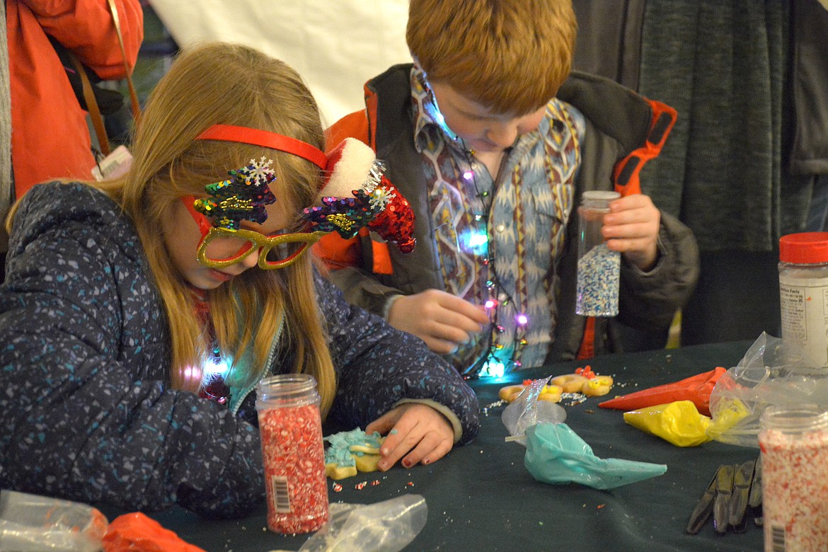 The cookie decorating table inside the warm event tent was a popular spot. (Mineral Independent/Amy Quinlivan)