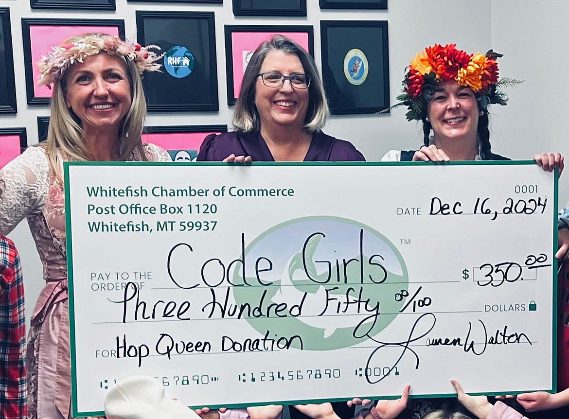 Lauren Walton, Marianne Smith of Code Girls United and Casey Shelton present a hop queen donation check to Code Girls. (Photo provided)