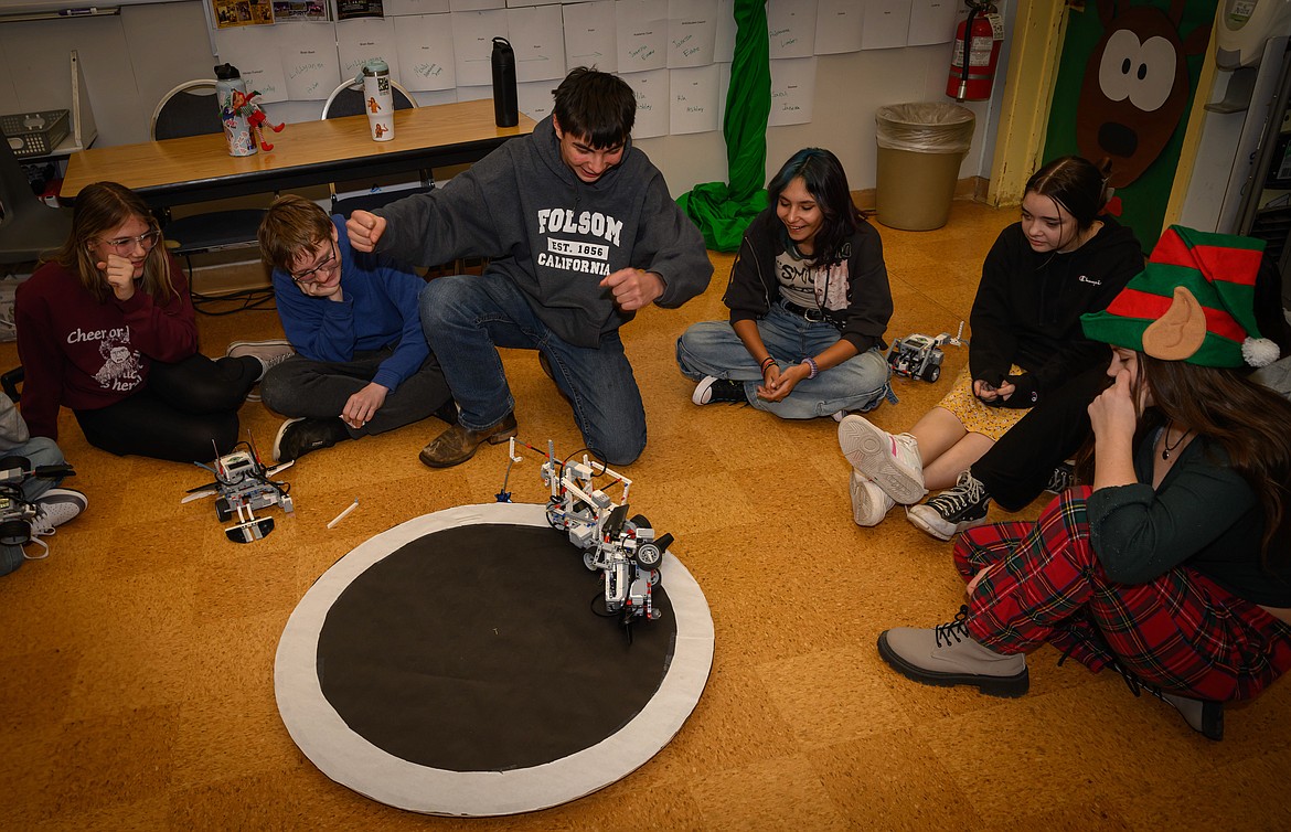 Gary Rehbien's robot Tyrone topples Kiara Browns robot Walle during the 8th grade Robotics Class competition. (Tracy Scott/Valley Press)