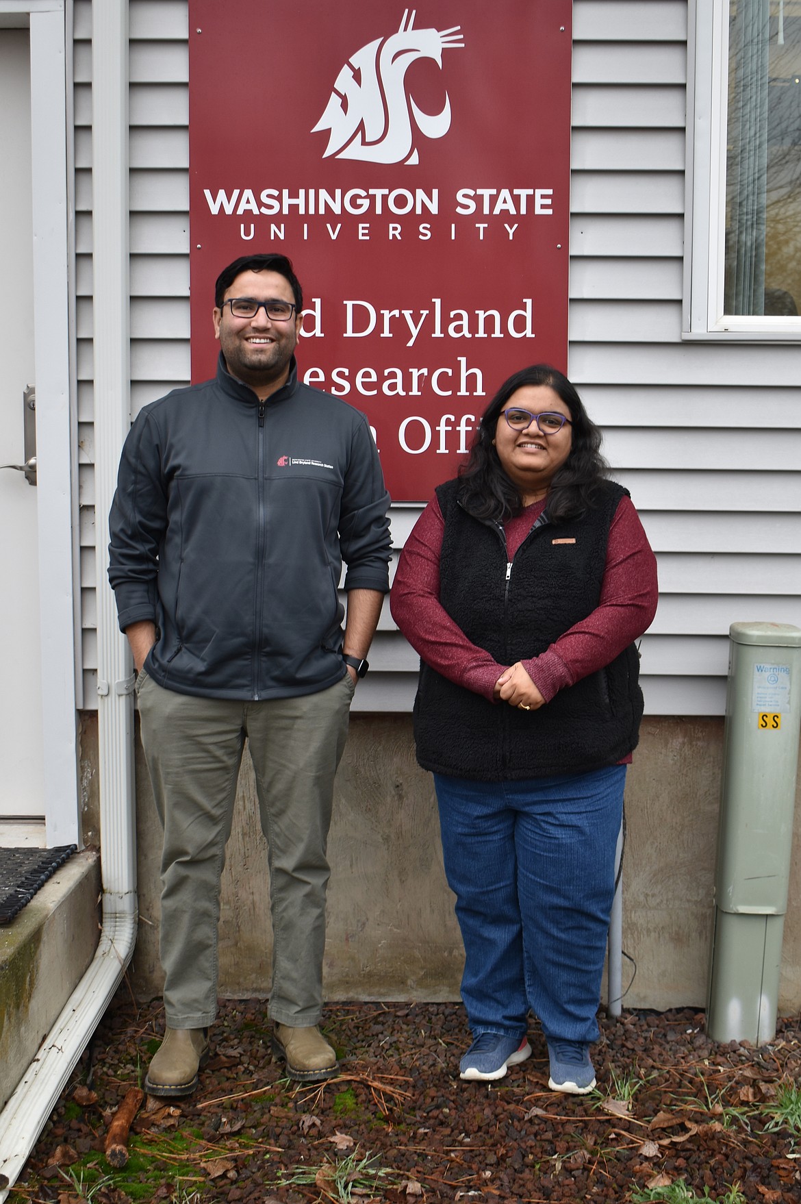 Surendra, left, and Shikha Singh stand outside the office of the Washington State University Lind Dryland Research Station. The Singhs came to the station in April 2023, Surendra as director and Shikha as an assistant research professor.