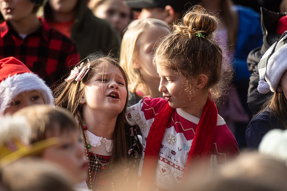 A duo of elementary school carolers at the downtown Christmas tree Friday, Dec. 20. (Avery Howe/Bigfork Eagle)