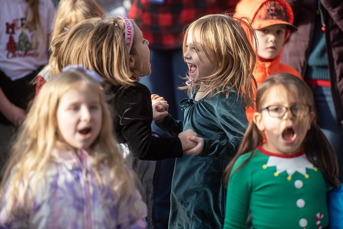 A pair of carolers dance along to the tunes at Bigfork Elementary School's Christmas caroling Friday, Dec. 20. (Avery Howe/Bigfork Eagle)