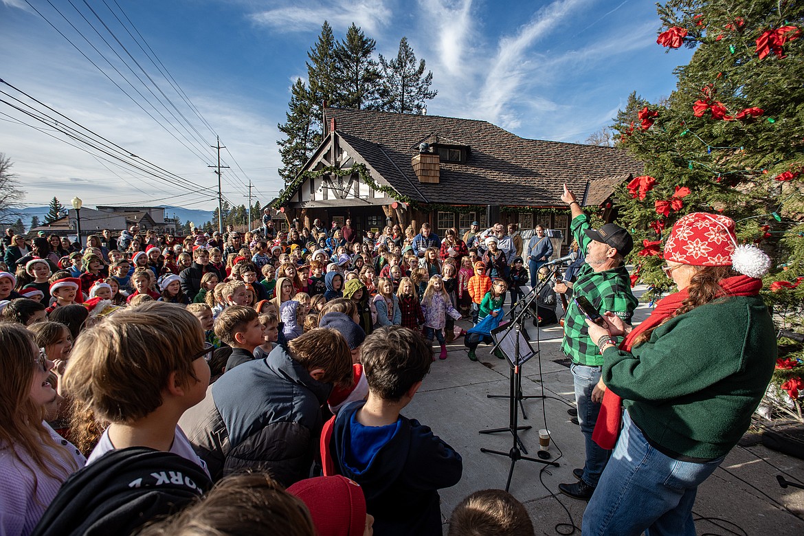 Bigfork Elementary School, led by Tommy Edwards Jr. and Sr. along with music teacher Heather Epperly, sing carols under the downtown Christmas tree Friday, Dec. 20. (Avery Howe/Bigfork Eagle)