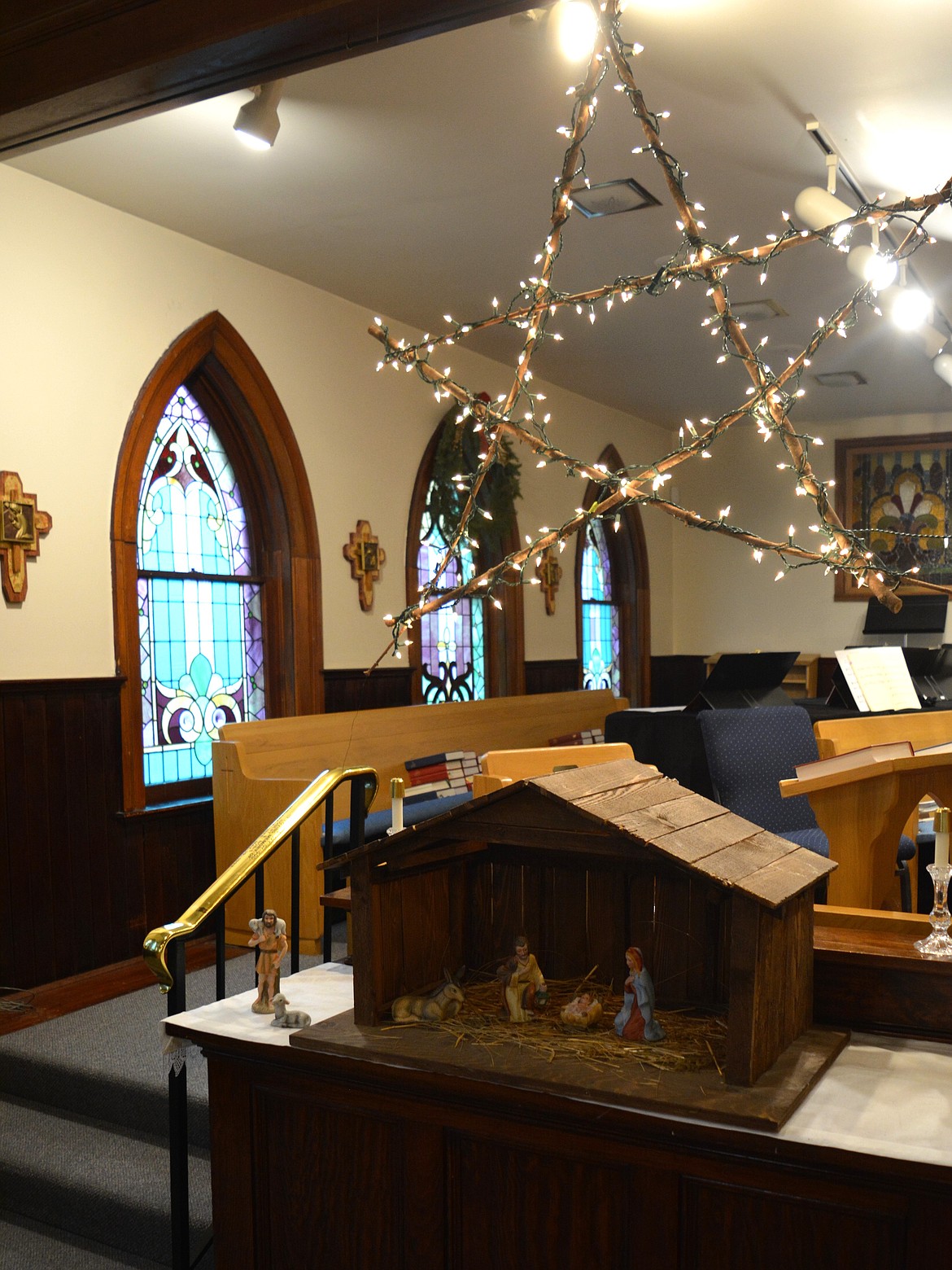 A nativity scene with a star made from wooden sticks and lights adorns St. Luke's Episcopal Church.