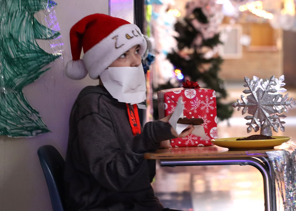 Zack Kilgore dons a Santa outfit as he hands out cookies during the "Deck the Halls" competition at Lakes Middle School.