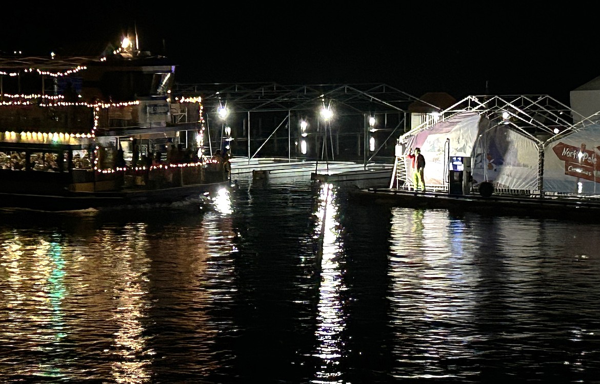 The Grinch greets a returning Lake Coeur d'Alene Cruises boat on Sunday.