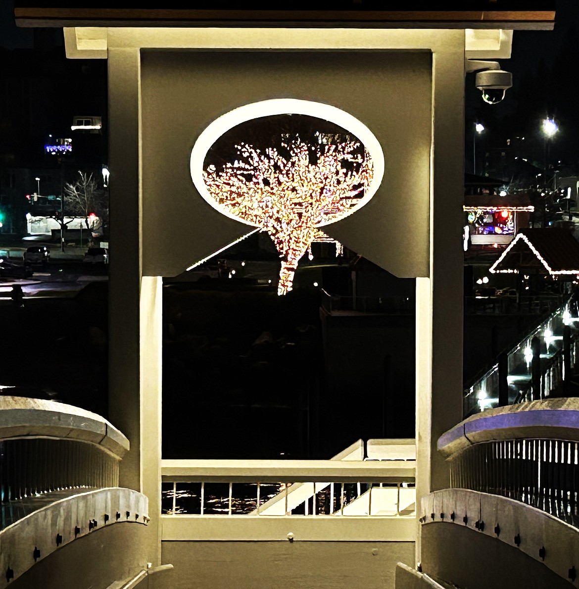 A lighted tree is seen through the arch of the bridge on The Boardwalk Marina on Sunday.