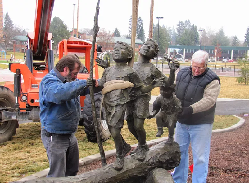 In 2014, Tim McCormick, left, and John Kinkade install “The Explorers.”