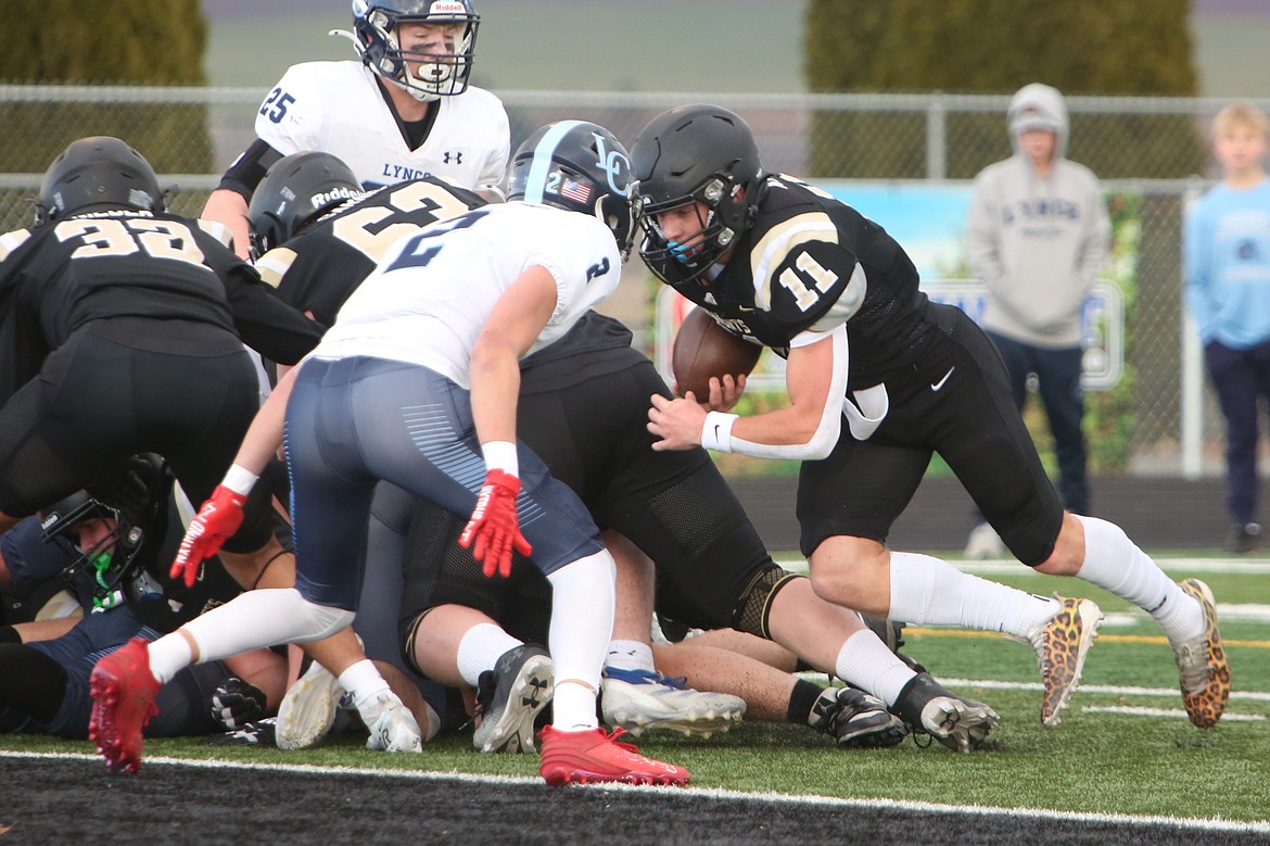 Royal senior Lance Allred (11) powers his way into the end zone on a carry near the goal line against Lynden Christian. Allred ran for at least two touchdowns in each of Royal’s playoff games this season, including six in the state championship game.