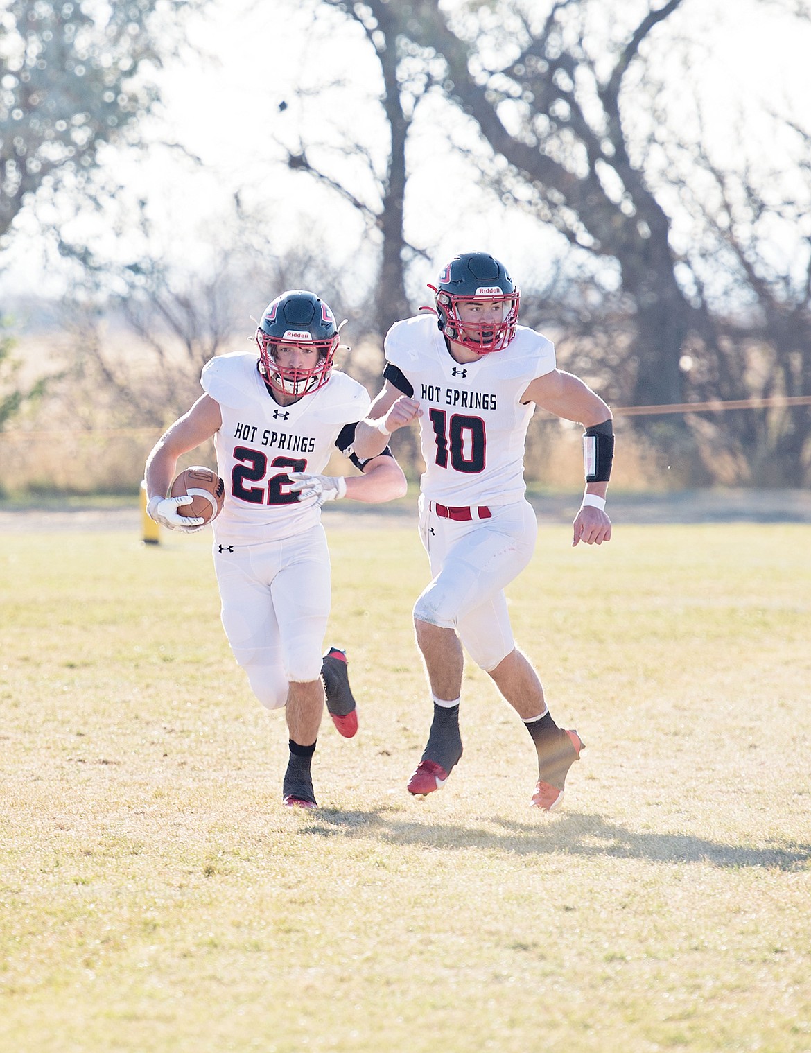 All state Six-player selections Weston Slonaker (22) and quarterback Nick McAllister (10) during their semifinal playoff game versus Box Elder this past season. (Photo by Teresa Waterbury)