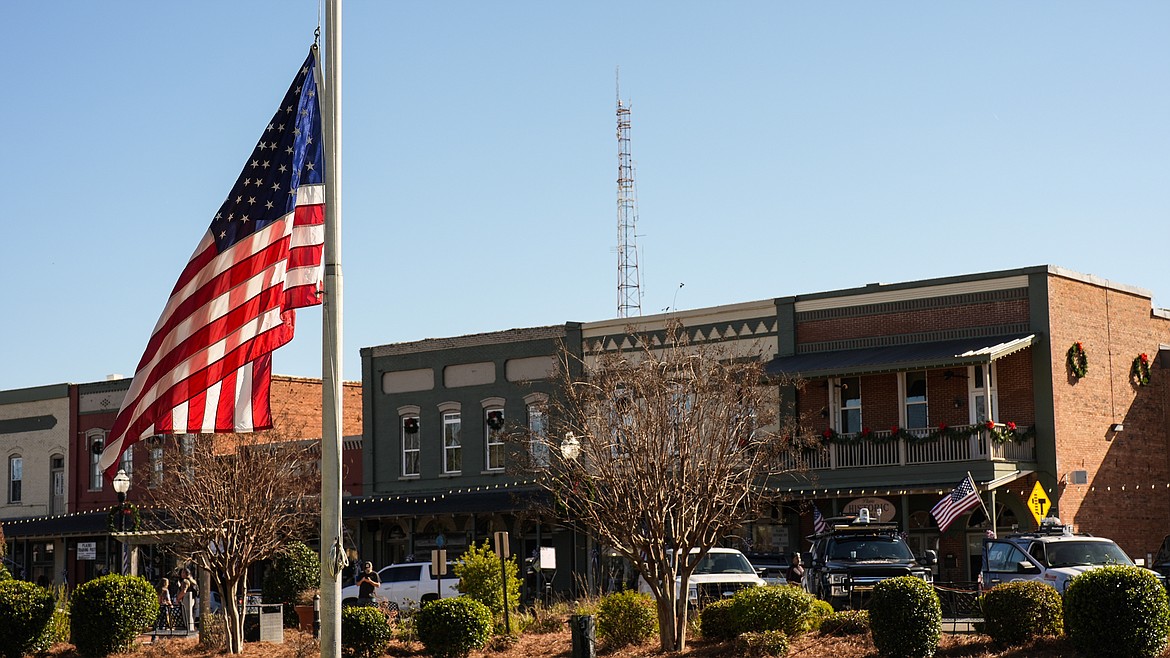 A flag flies at half-staff on Main Street in the aftermath of former President Jimmy Carter's death Monday in Plains, Ga. Carter died Sunday at the age of 100.