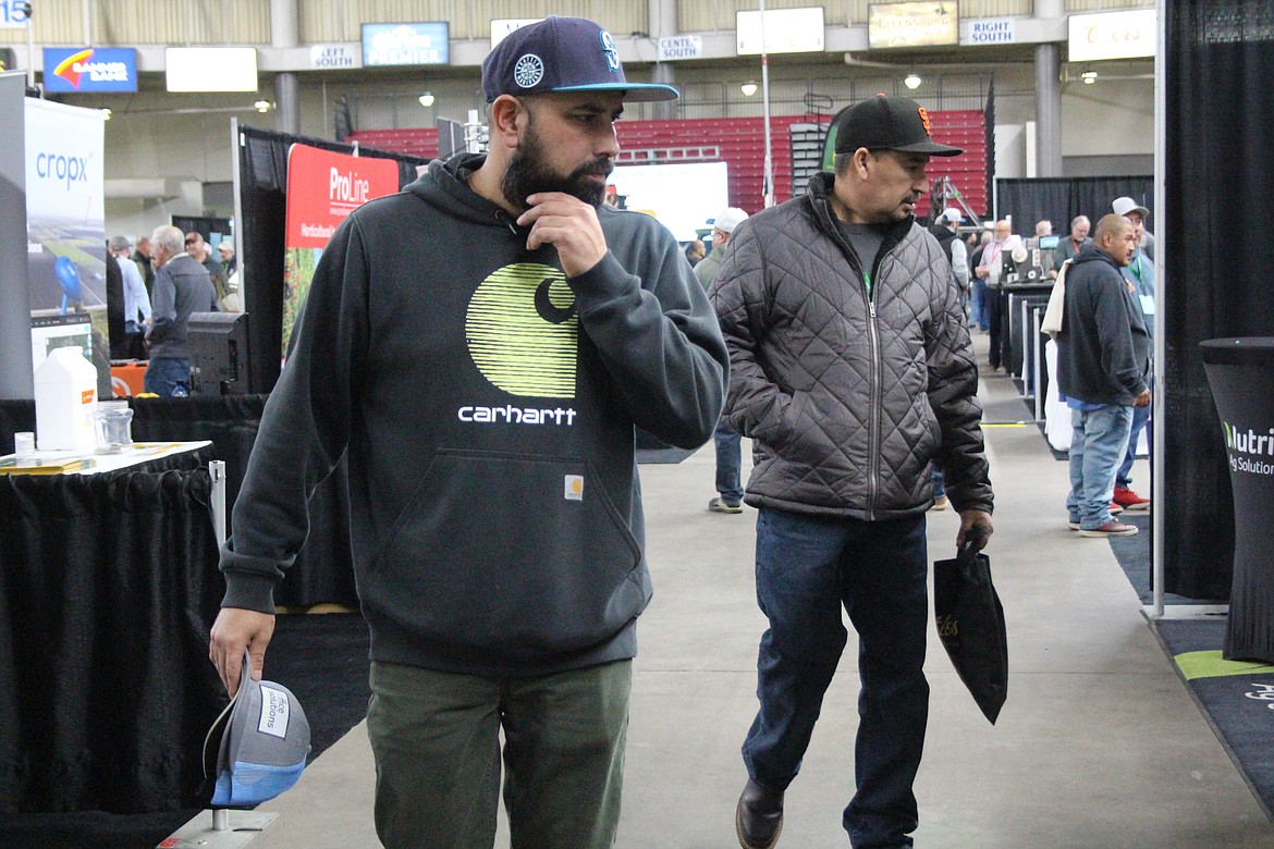 Tree fruit association annual meeting attendees peruse the many types of technology and equipment on display.