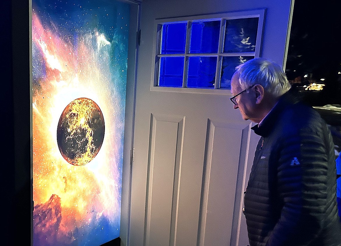 Richard Jaggi looks inside one of The Doors at McEuen Park that are part of the Winter Lights celebration in downtown Coeur d'Alene.