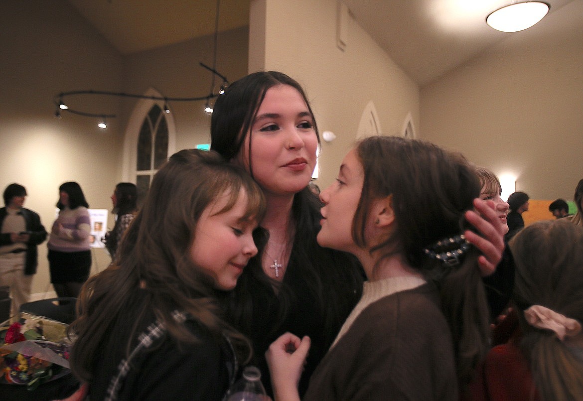 New Vision Alternative High School junior Eva Santiago-Rosenberg receives hugs from Post Falls Boys and Girls Club kids Toreana Best, left, and Serenity Murray after it was announced in January that Santiago-Rosenberg was the 2024 Kootenai County Boys and Girls Clubs Youth of the Year.