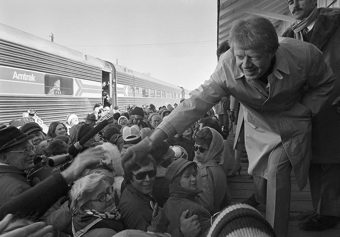 R\Former President Jimmy Carter reaches into crowds of people to shake hands. 13th District State Rep. Tom Dent said he admired how Carter spoke to citizens and often made time to do so, with his wife and himself even riding in economy and talking with people on the plane.