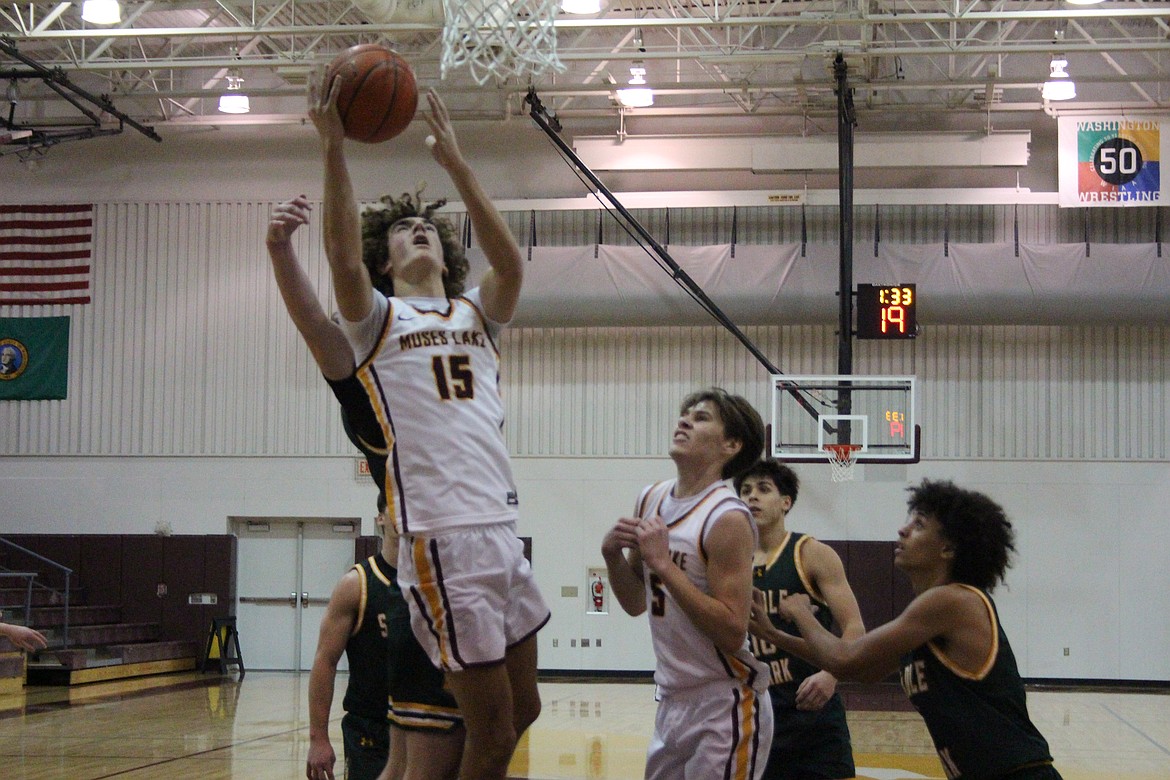 Moses Lake junior Grady Walker (15) attempts to lay the ball in for a basket during Monday’s game against Shadle Park. Walker scored 13 points in the win.