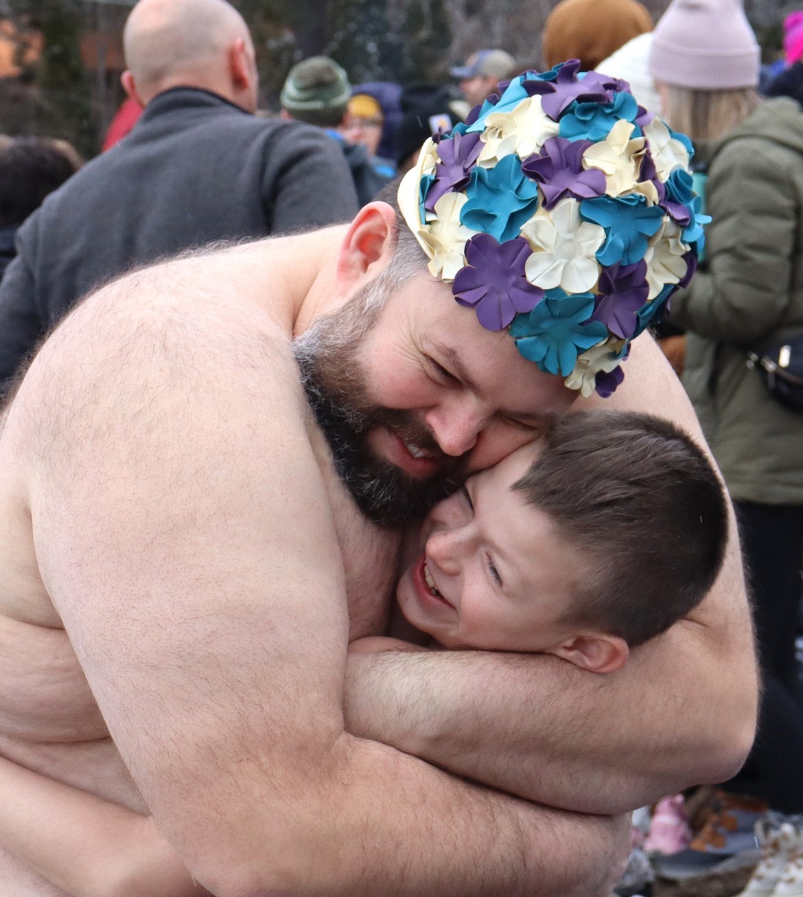 Mickael Stevens and son Guster of Coeur d’Alene share a hug prepare for the Polar Bear Plunge at Sanders Beach on New Year's Day.