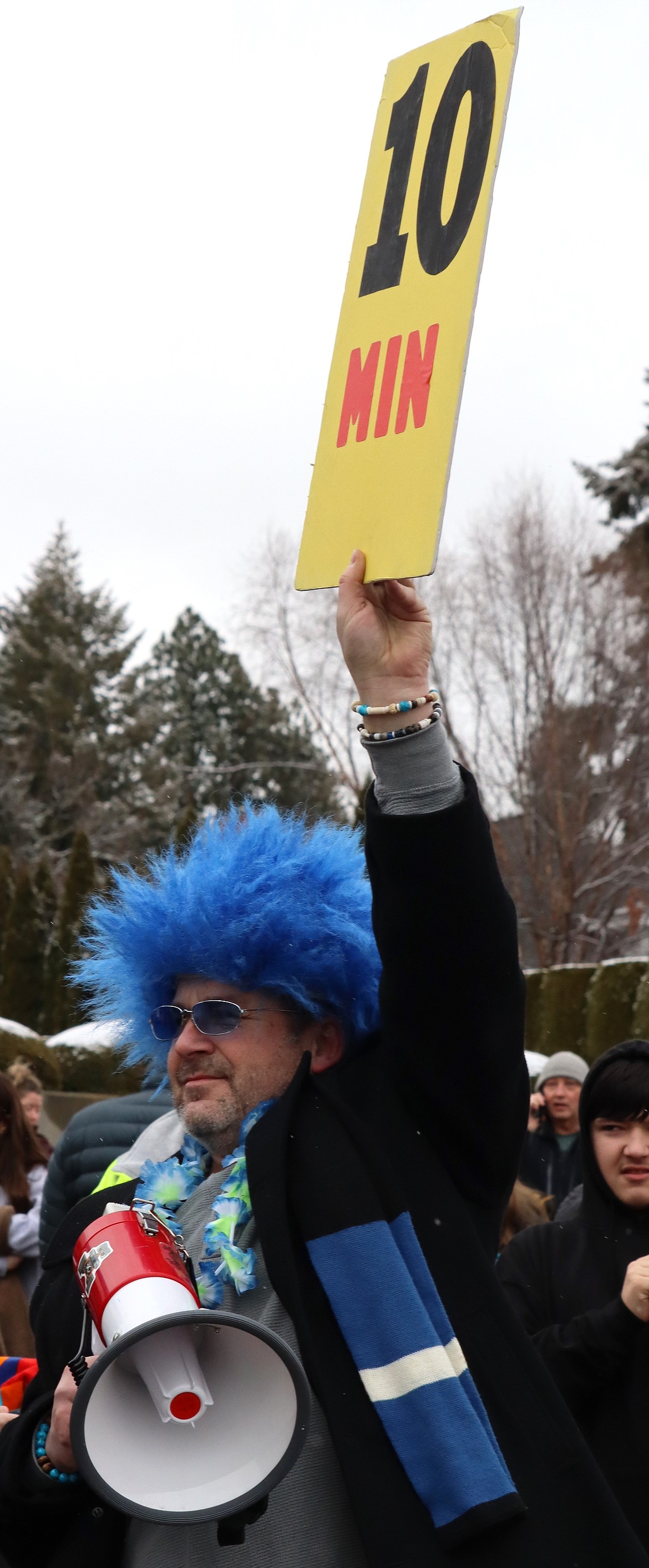 Chad Bennett holds a sign high as part of the countdown to the Polar Bear Plunge at Sanders Beach on New Year's Day.