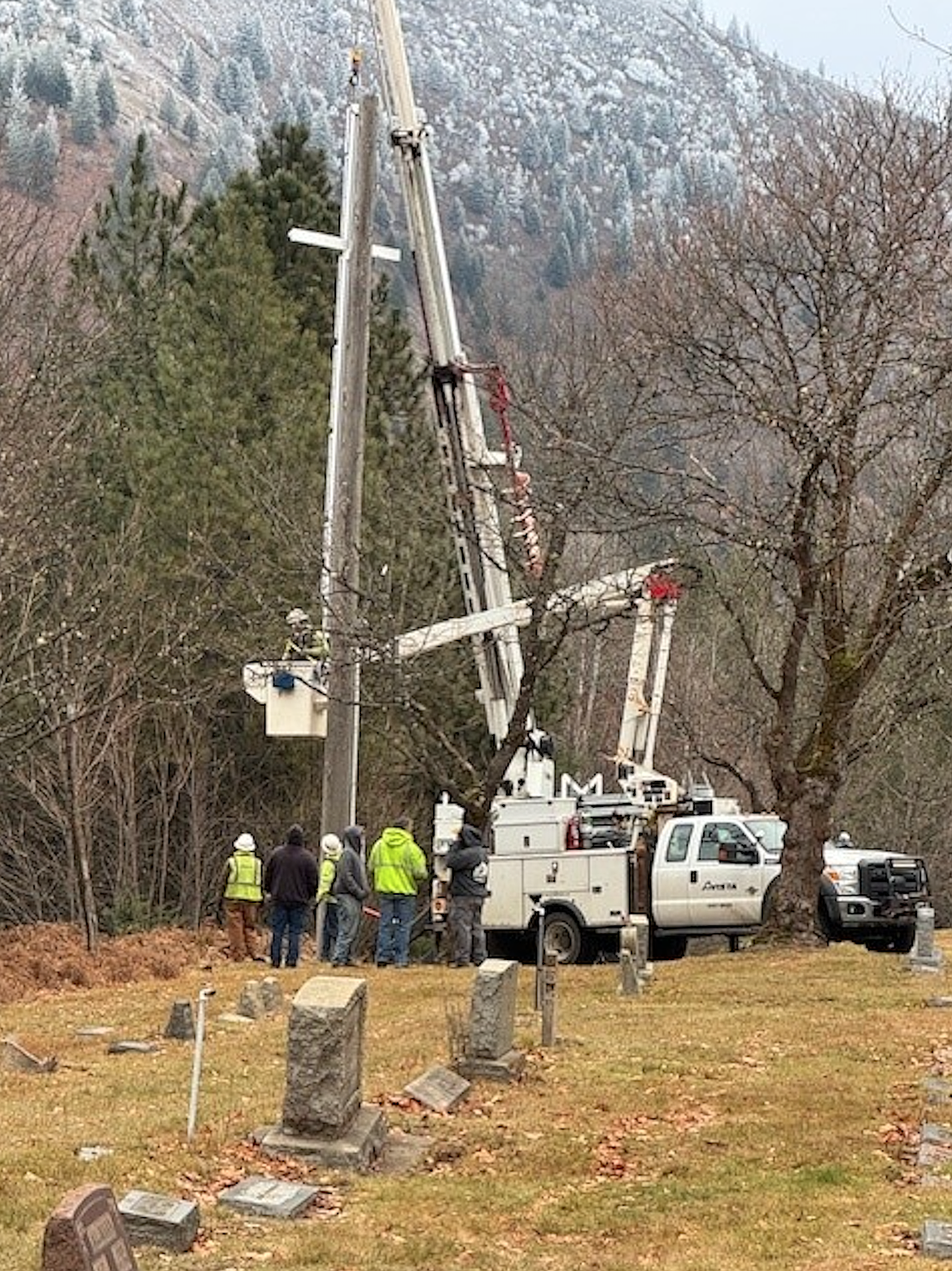 Crews from Avista Utilities set the pole with the new cross at Greenwood Cemetery late last year.