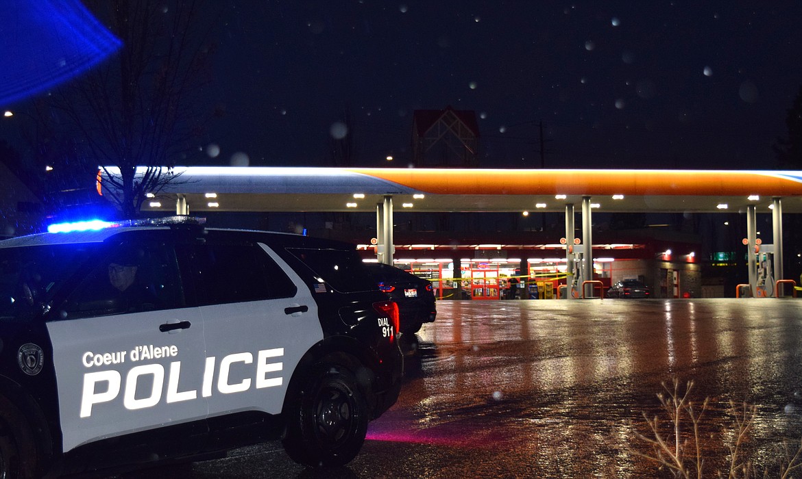 A Coeur d'Alene Police vehicle blocked the entrance as police investigated the scene of a shooting at the 76 station at the intersection of Northwest and Appleway.