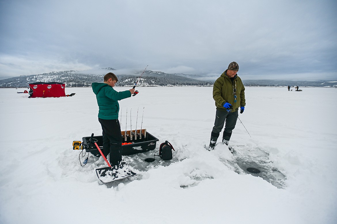 Lincoln Herbert and his father Don wait for bites at the 53rd annual Sunriser Lions Ice Fishing Derby on Smith Lake in Kila on Saturday, Jan. 4. (Casey Kreider/Daily Inter Lake)