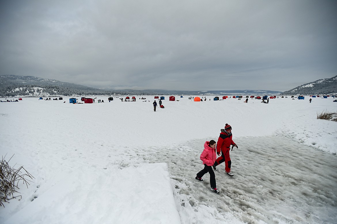 Participants carry a fish to shore to be measured at the 53rd annual Sunriser Lions Ice Fishing Derby on Smith Lake in Kila on Saturday, Jan. 4. (Casey Kreider/Daily Inter Lake)