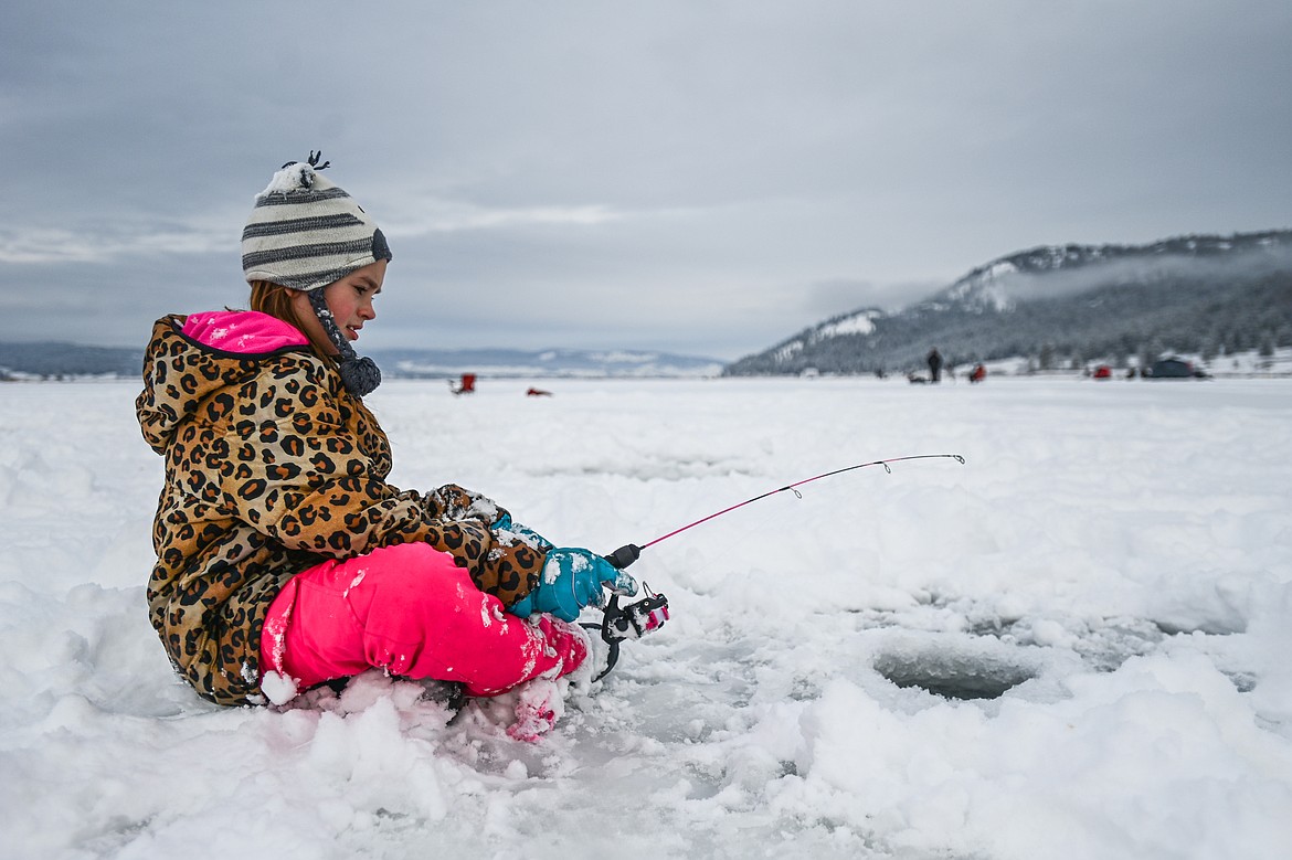 Sophia Naethe waits for a fish to bite at the 53rd annual Sunriser Lions Ice Fishing Derby on Smith Lake in Kila on Saturday, Jan. 4. (Casey Kreider/Daily Inter Lake)