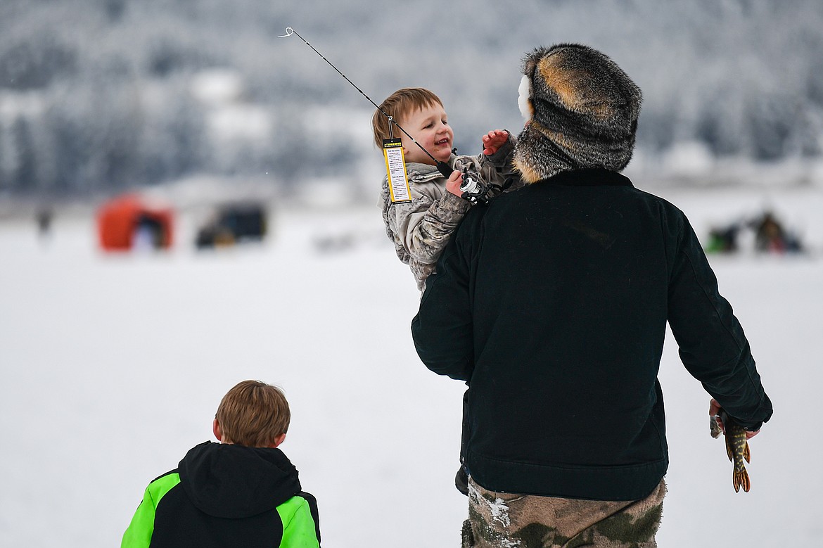 A young boy carries a new fishing rod won at the 53rd annual Sunriser Lions Ice Fishing Derby on Smith Lake in Kila on Saturday, Jan. 4. (Casey Kreider/Daily Inter Lake)