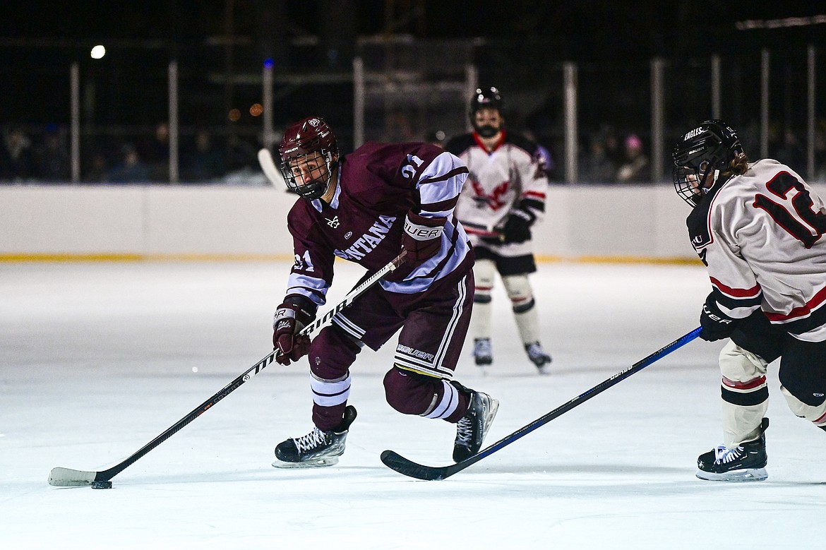 Griz forward Eitan Geralnick (21) pushes the puck into the Eastern Washington zone during the Winter Classic at Woodland Park Ice Rink in Kalispell on Saturday, Jan. 4. (Casey Kreider/Daily Inter Lake)