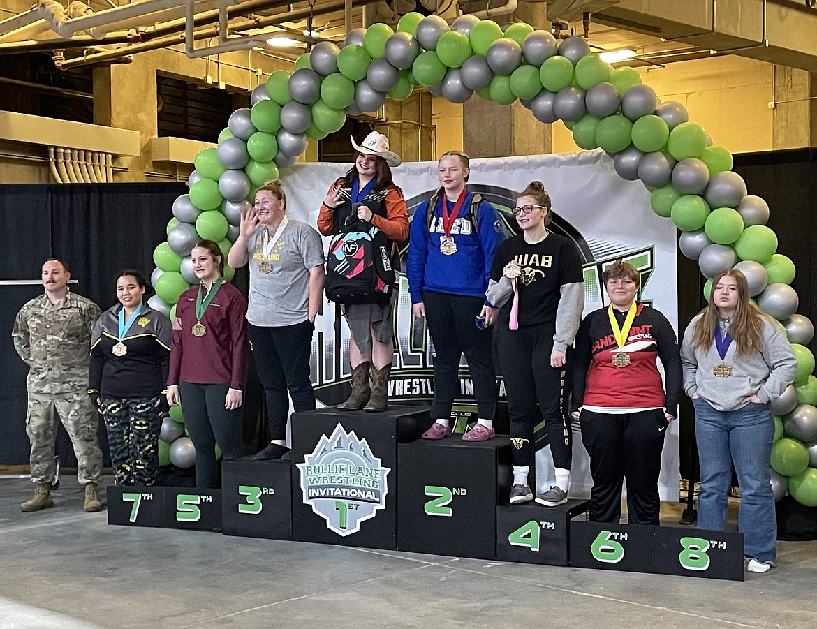 Sandpoint's Lilli Marti, second from right, is all smiles after placing sixth in the girls 235-pound bracket on Saturday.