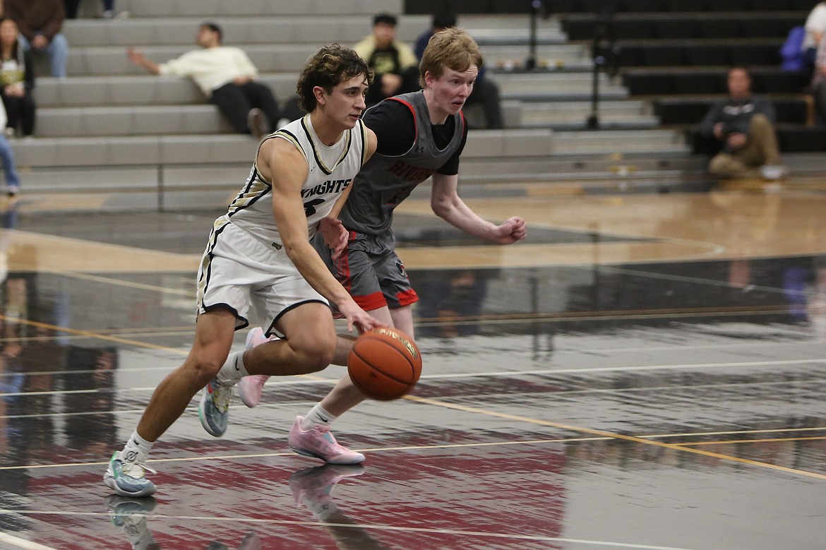 Royal senior Ezra Jenks, left, dribbles the ball up the floor in the first quarter against Riverside on Friday. Jenks led the Knights with four made three-pointers in the win, three of which came in the second quarter.