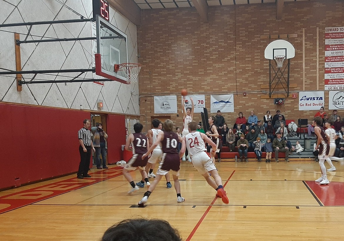 Noxon players head toward the basket for a potential rebound of a shot by Shane Hatchell during their game against Troy this past Saturday in Noxon.  (Photo by Poppy Kayser)