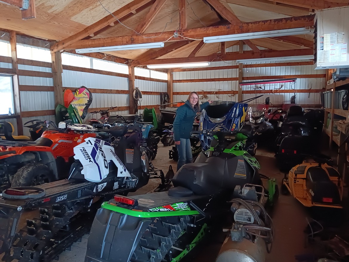 Brogan Keenen, manager of the $50,000 Bar in Haugan, explains the different types of snowmobiles for the different needs of people from their family toy-shed. The upcoming Winterfest 2025 and $1,000 Super Poker Ride this month will be headquartered at the $50,000 Bar.