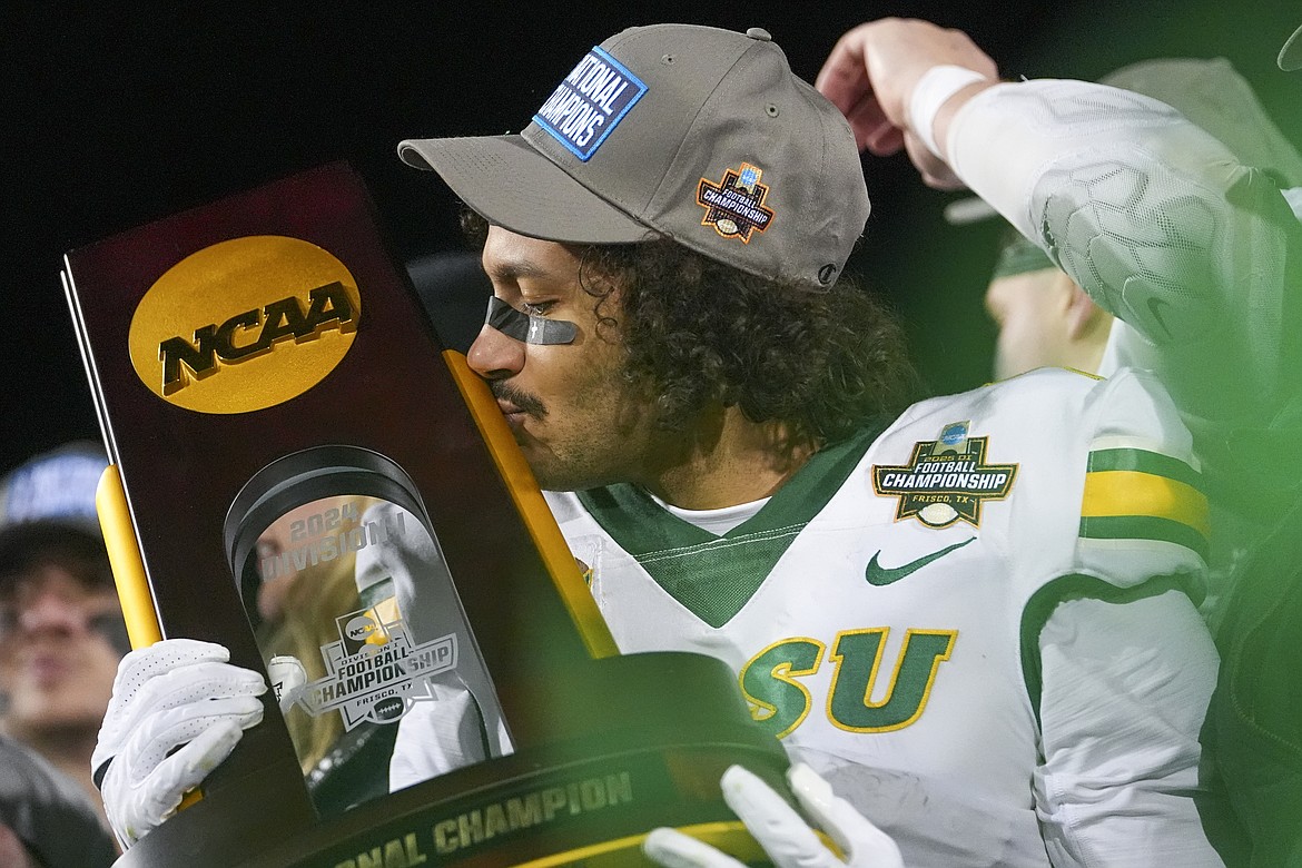 North Dakota State wide receiver Braylon Henderson kisses the trophy following the FCS Championship NCAA college football game against Montana State, Monday, Jan. 6, 2025, in Frisco, Texas. North Dakota State won 35-32. (AP Photo/Julio Cortez)