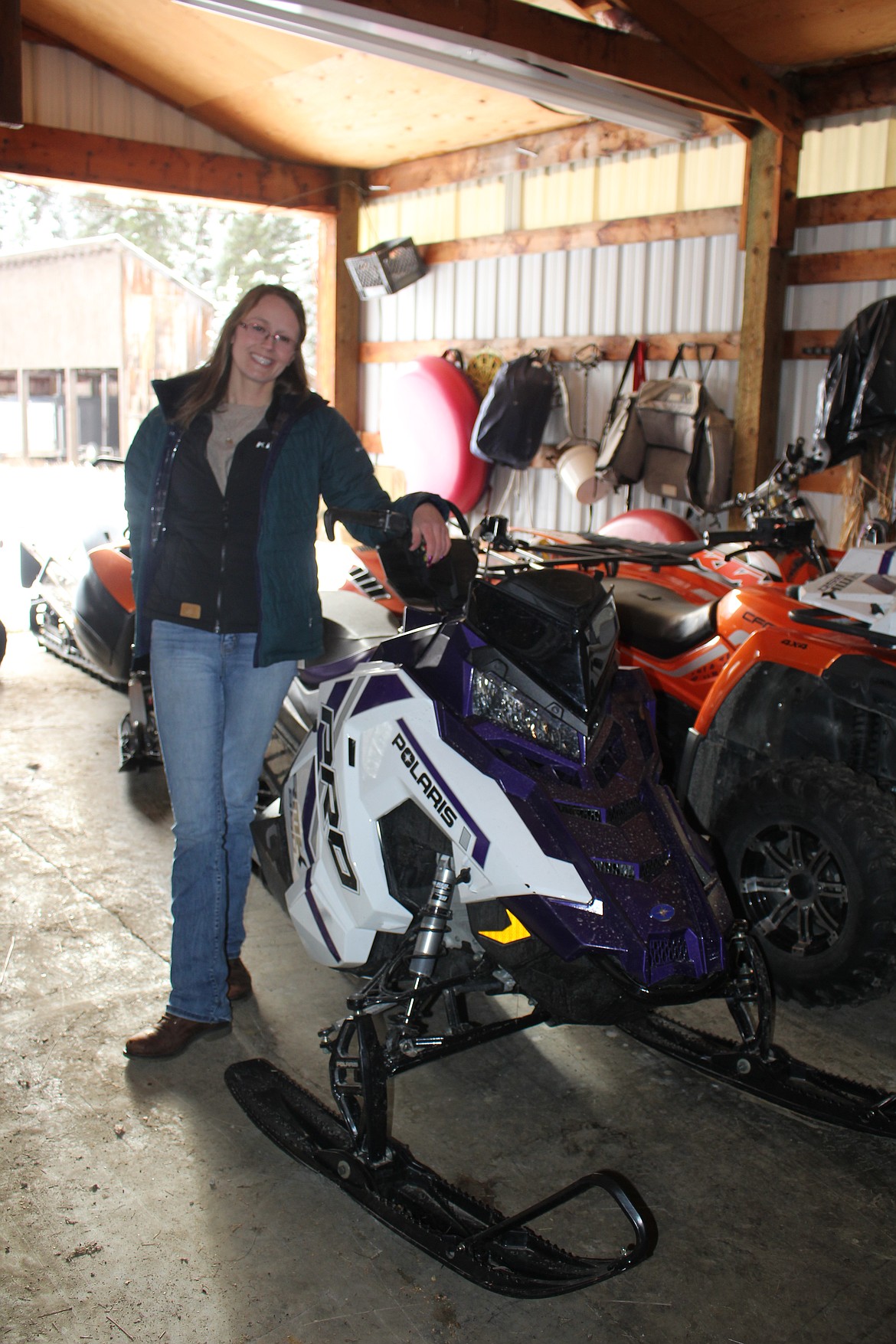 Brogan Keenen, manager of the $50,000 Bar in Haugan with her Polaris snowmobile that is built for vertical speed in deep snow. There might be some of this caliber at the $1,000 Super Poker Ride, but most participants will have wider machines that offer more comfort, but any style is welcome. (Monte Turner/Mineral Independent)