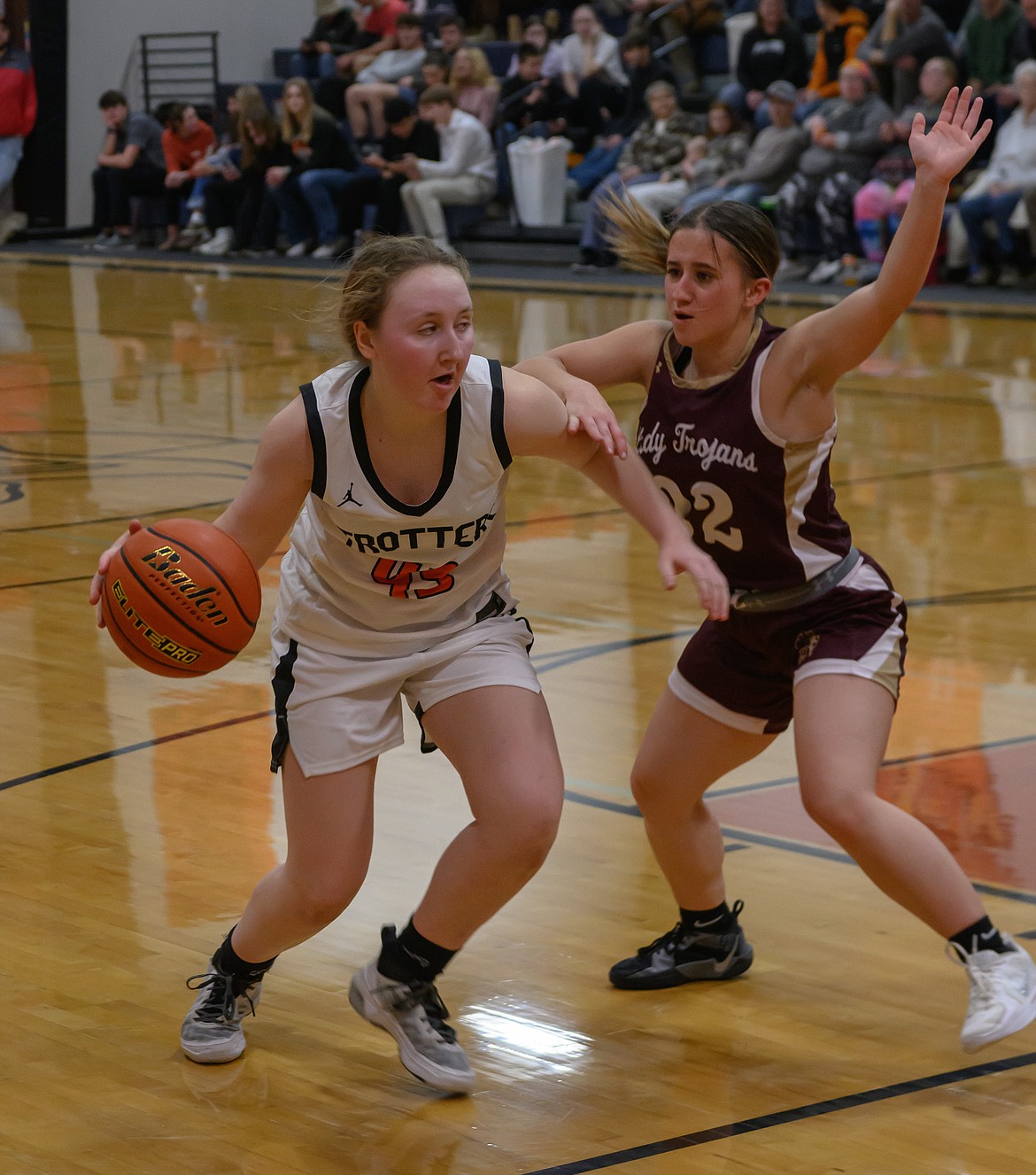 Ashley Ferlan (with ball) works to get past Troy's Leslie Gravier during the Trotters 48-25 win Thursday night in Plains. (Photo by Tracy Scott)