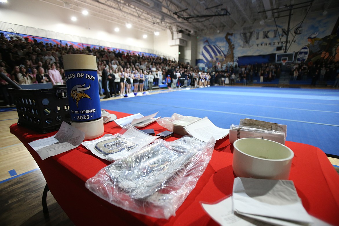 Coeur d'Alene High School "C" chenille patches, photos, newspaper clippings, state track medals and a brick from the original Coeur d'Alene High on Seventh Street were among the treasures uncovered Tuesday when a time capsule was opened in Viking Court during a school assembly. The capsule, created in 2000, was a legacy from the Class of 1950.