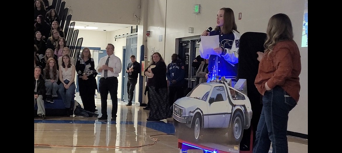 Media student Eva Brown, with a cardboard cutout of the "Back to the Future" DeLorean, introduces the time capsule project Tuesday at Coeur d'Alene High School.