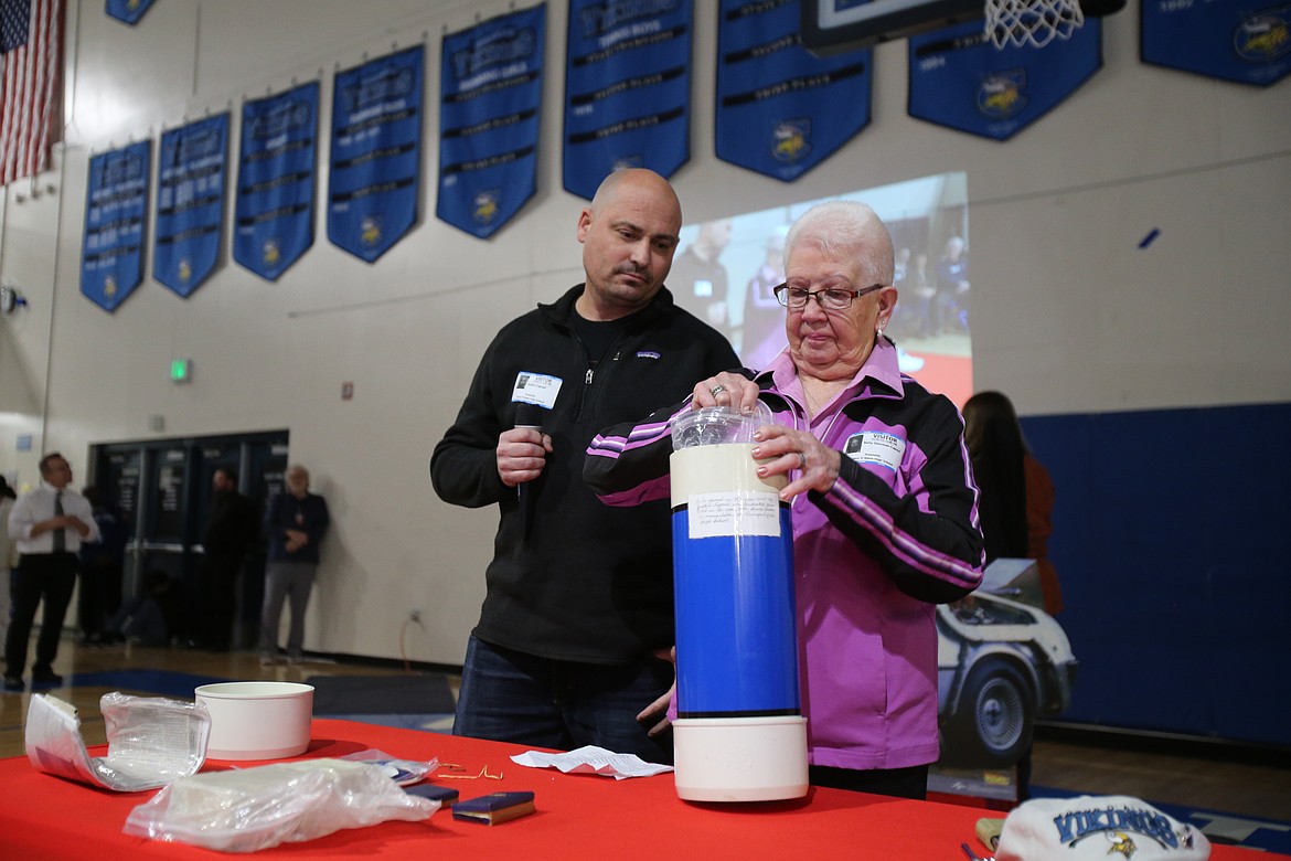 Year 2000 graduate Justin Capaul and grandmother Betty Capaul open a time capsule from the Coeur d'Alene High School Class of 1950 during a Tuesday afternoon assembly. Justin's grandpa Ray was the 1950 Coeur d'Alene High class president. Instructions on the capsule directed Justin to open it this year.