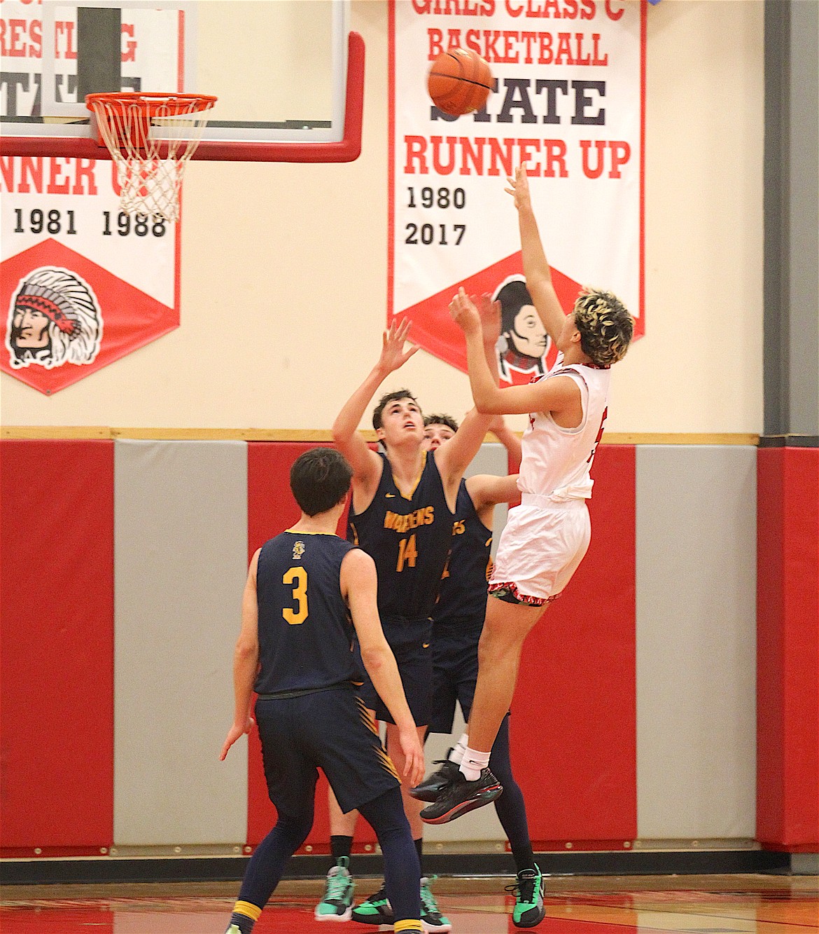 Warrior Dainian Marceau goes up for a basket during last week's game between Arlee and Deer Lodge. (Goplen Photography)