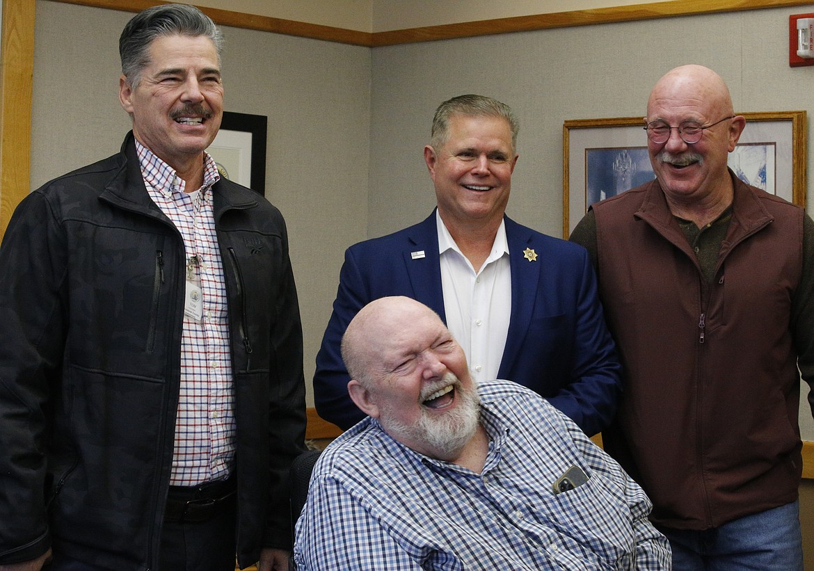 Kootenai County Veterans Services Director Tom Freeman, Kootenai County Sheriff Bob Norris, former undersheriff Dan Mattos and Kootenai County Commissioner Bill Brooks share a laugh Tuesday during Brooks' farewell open house.