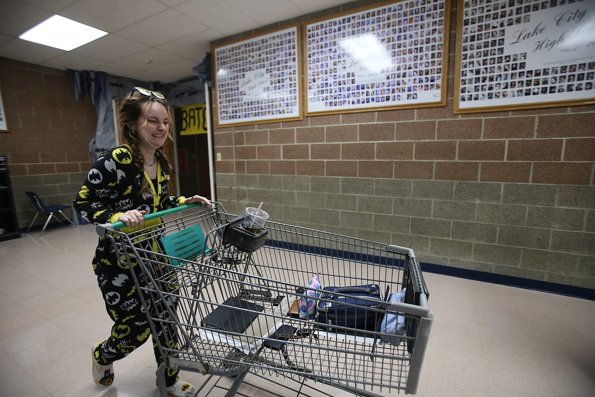 Kyli Swofford, a Lake City High junior, is decked out with Batman PJs as she rolls her stuff through the school in a shopping cart during Tuesday's "Anything but a Backpack" spirit day.