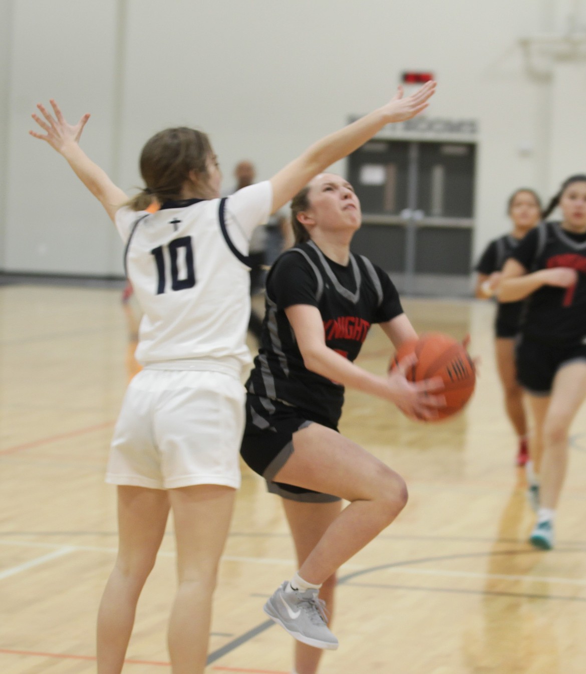 JASON ELLIOTT/Press
Lakeside junior guard Kyleigh Wolfe drives past Genesis Prep senior guard Ella Martin in the first quarter of Wednesday's game at The Courts at Real Life in Post Falls.