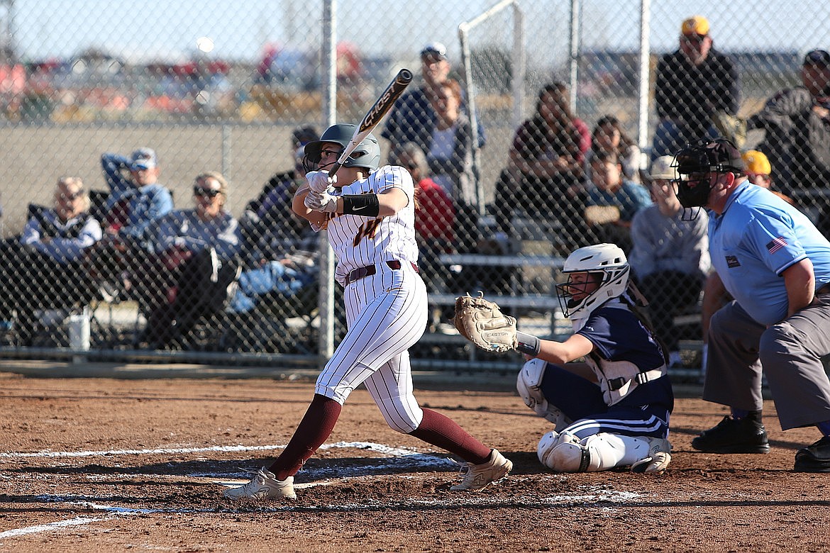 MLHS senior Paige Richardson, in white, swings her bat during a game last spring.